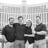 Family posing in front of the Bellagio Fountain on the Las Vegas Strip — joyful evening cityscape moment.