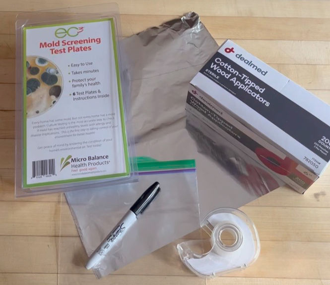 mold test plates, foil, marker, tape, applicators, baggie flat lay