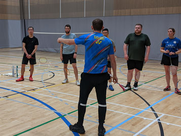 players under instruction from badminton coach Ben Muir