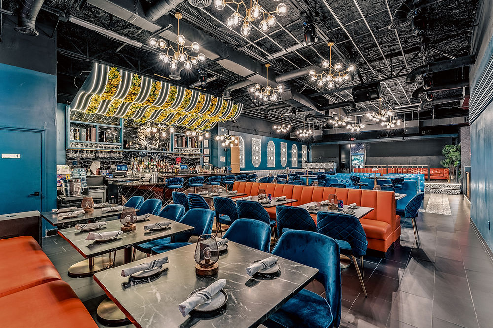 Stylish restaurant interior with blue and orange seating