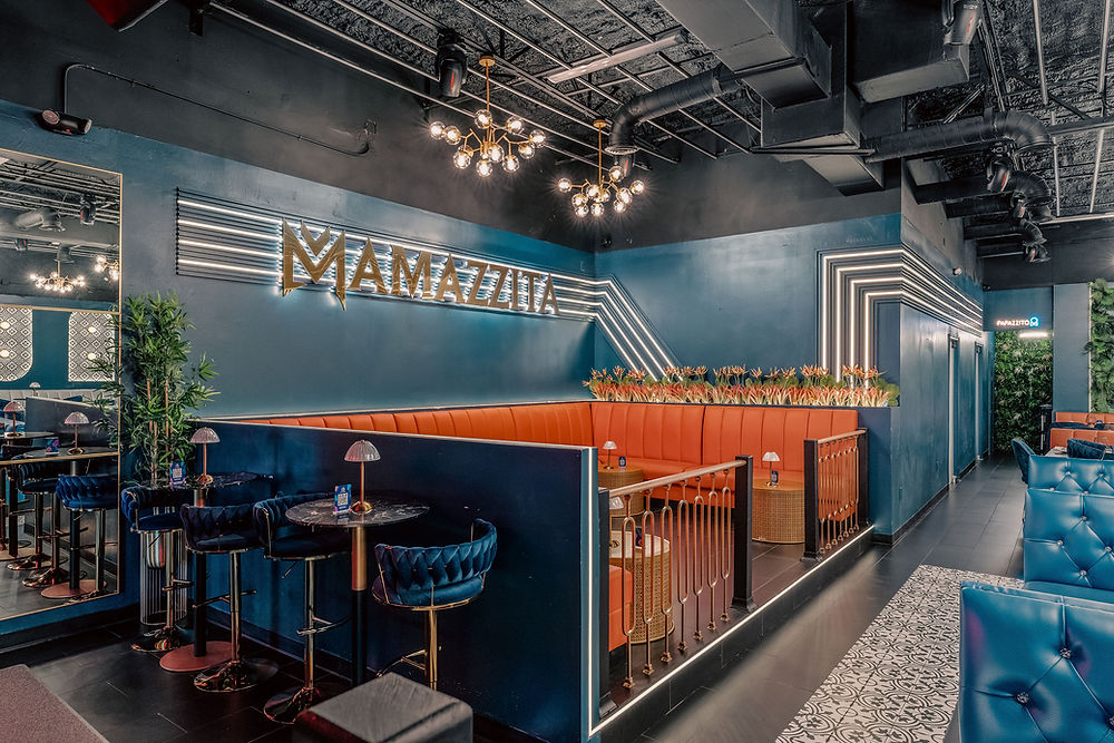 Modern Mamazita restaurant bar interior with blue and orange decor