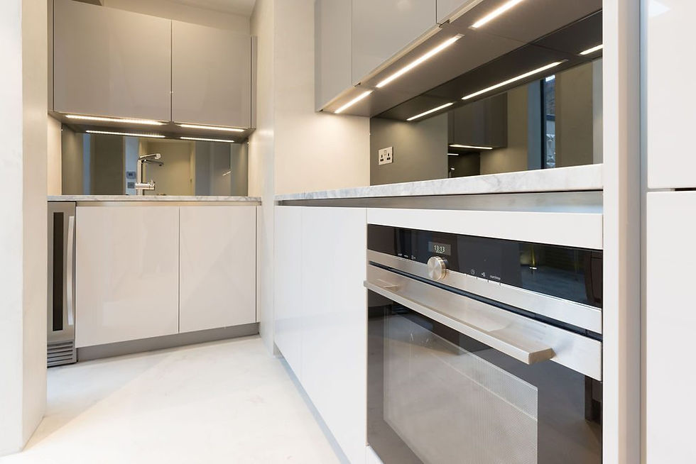 Modern white grey kitchen cabinetry, marble kitchen top and LED lights under the cupboards