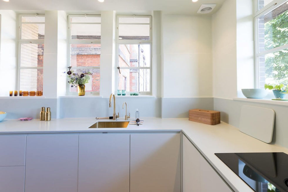 Soft green kitchen cabinetry, worktop, splash and walls. Renovation by Absolute Project Management.