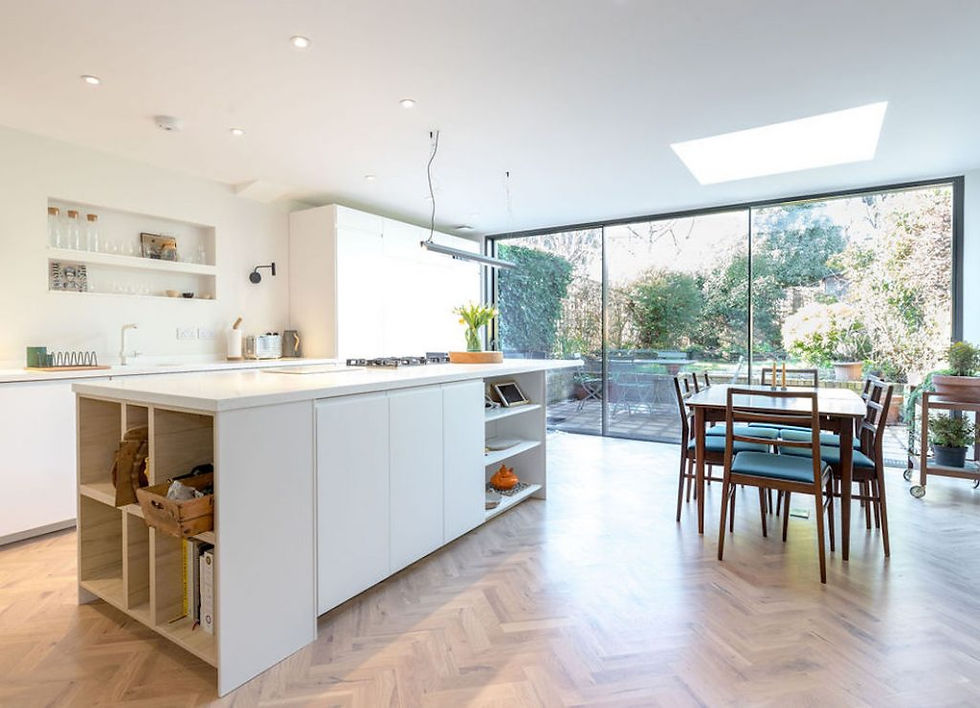 Bright white open kitchen/dining space with lovely natural light and stunning parquet wood flooring - Renovation by Absolute Project Management
