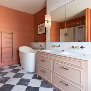 Bathroom with chequerboard marble floor and bespoke plaster-pink vanity