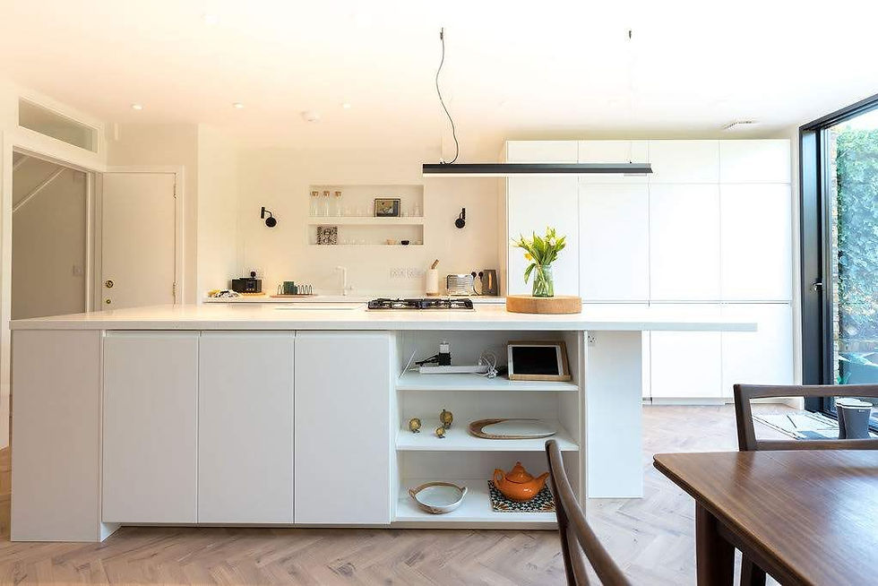 Matt white cabinetry, walls and alcove shelving keep this kitchen fresh and bright. Renovation by Absolute Project Management