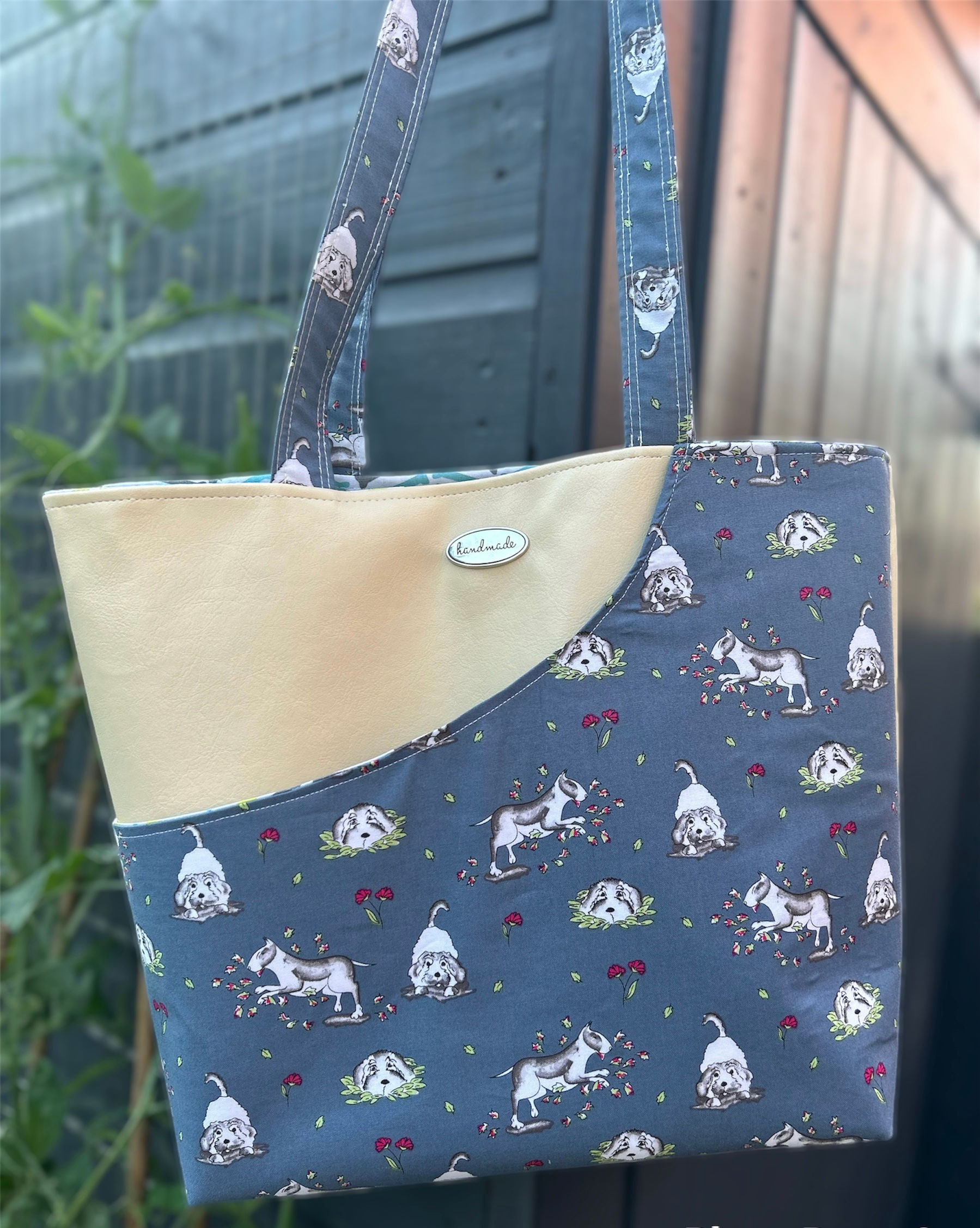 Dogs dancing in the flowers tote bag