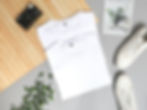 Clothing items on a desk with a camera