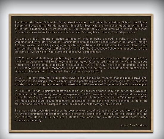 Close-up of bronze figures from the 'Dozier Memorial' — emotional realism capturing remembrance and healing.
