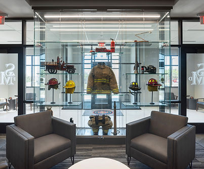Contemporary office lobby design featuring lounge chairs and a custom glass display wall. This project showcases commercial-grade furniture, and integrated architectural elements that enhance workplace design, branding, and user experience in corporate and public environments.