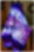 Purple and white tie-dye blanket draped over a wooden chair
