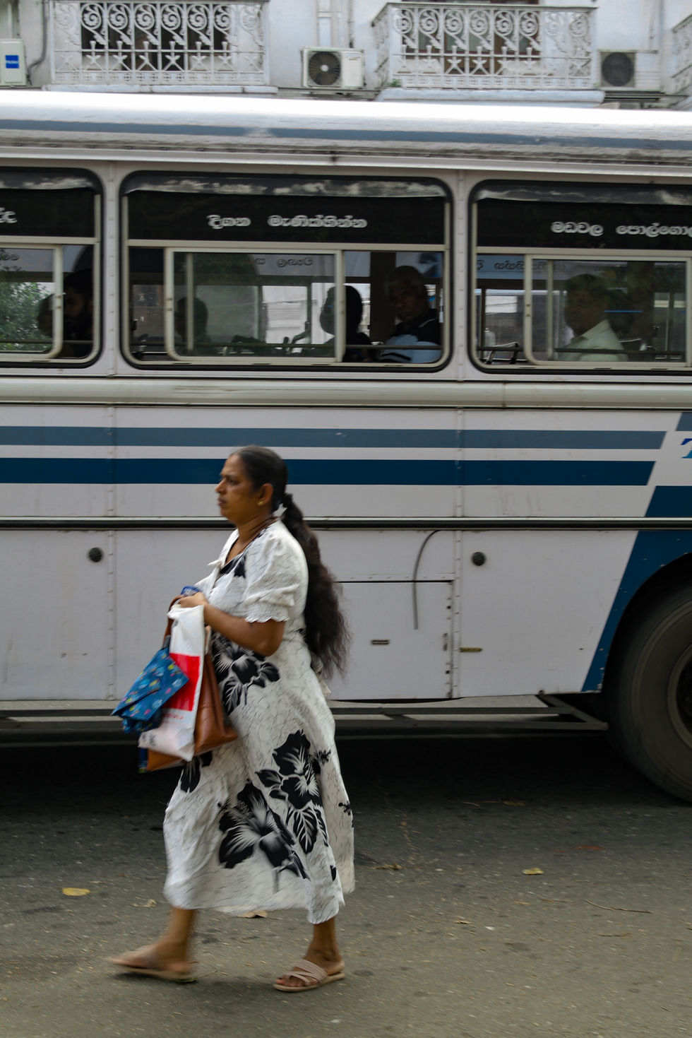 woman getting off the bus in Kandy, Sri Lanka