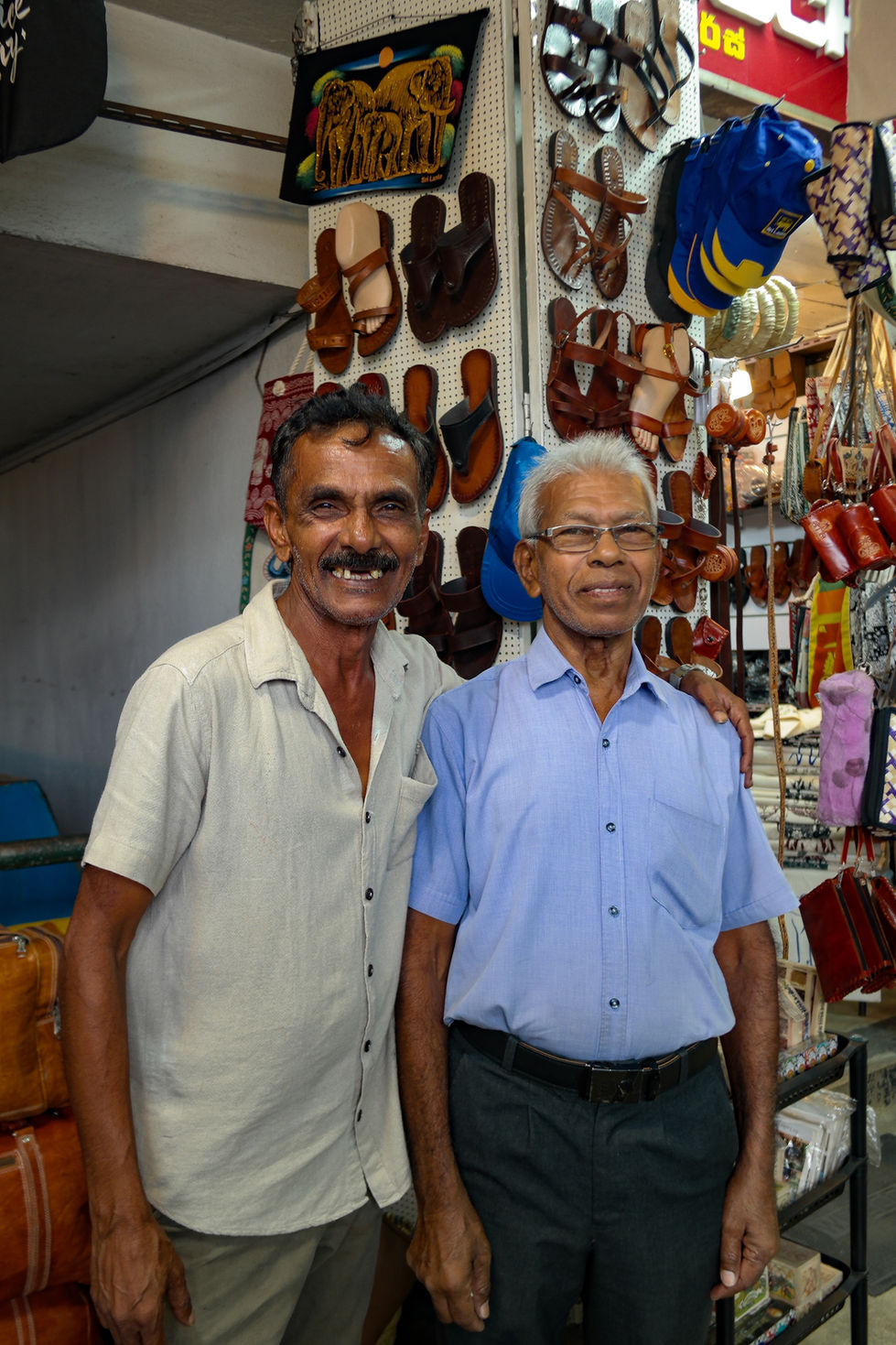 two men smiling while hugging in Kandy, Sri Lanka