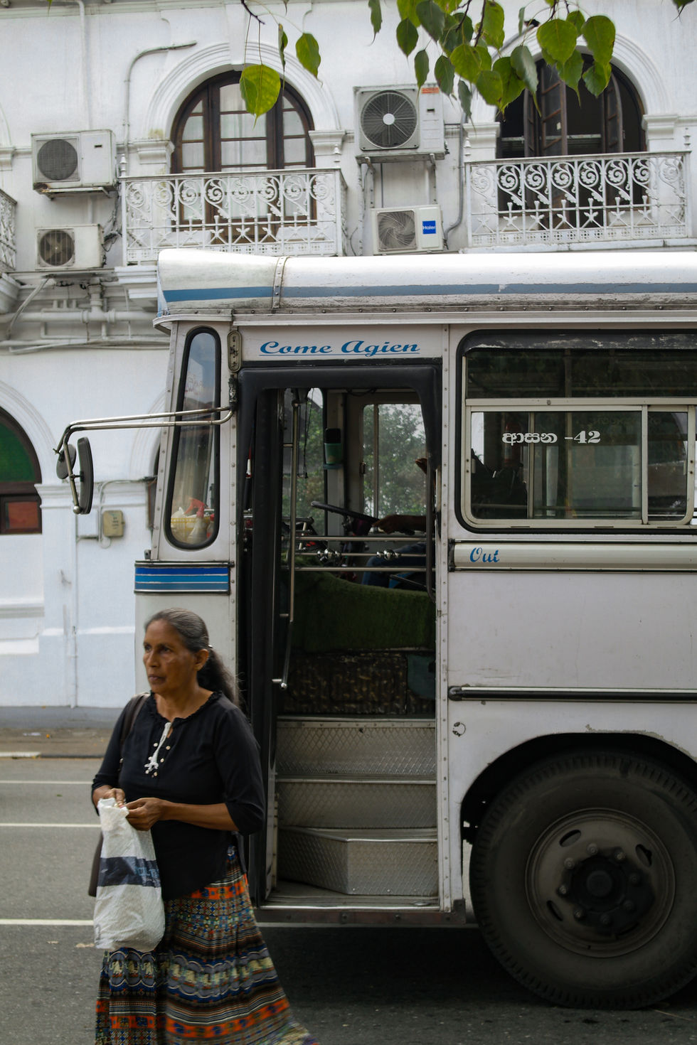 woman getting off the bus in Kandy, Sri Lanka