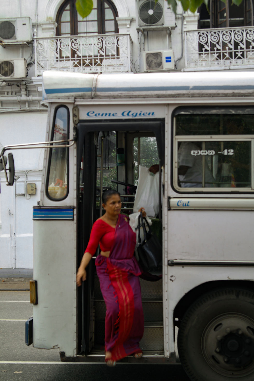 woman getting off the bus in Kandy, Sri Lanka