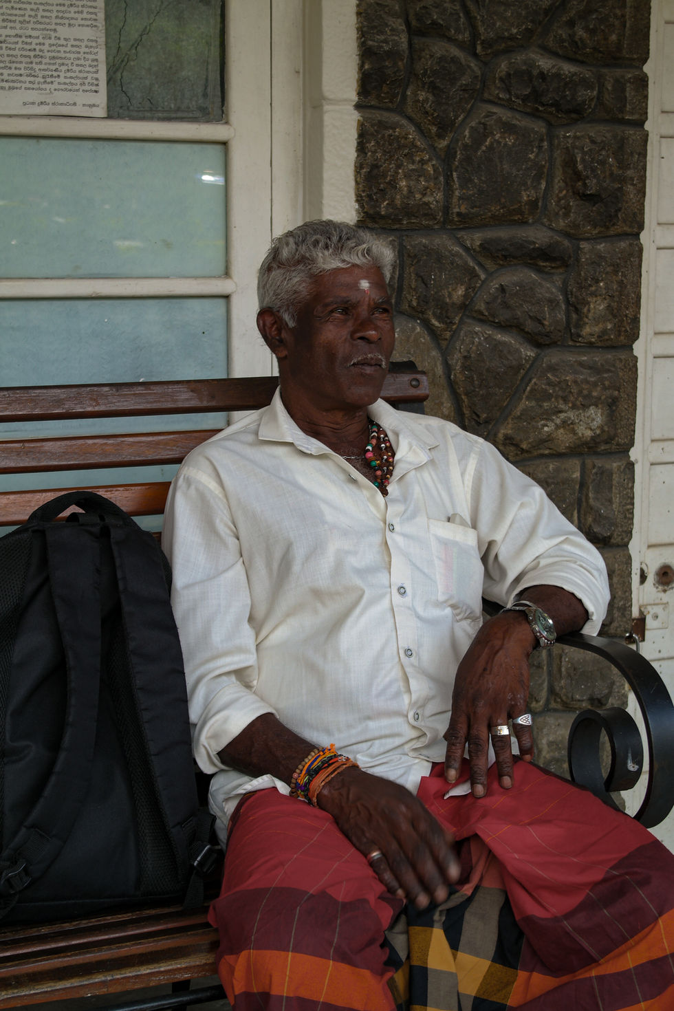 man smiling at the railway station in Sri Lanka