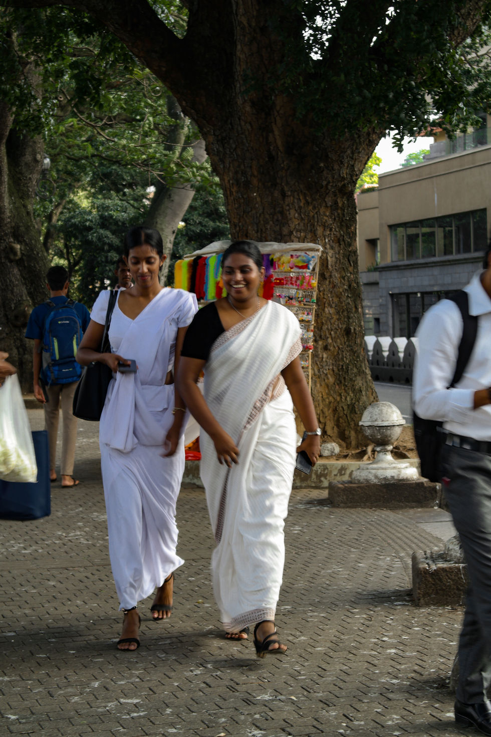 two girls walking and laughing wearing traditional Indian clothes