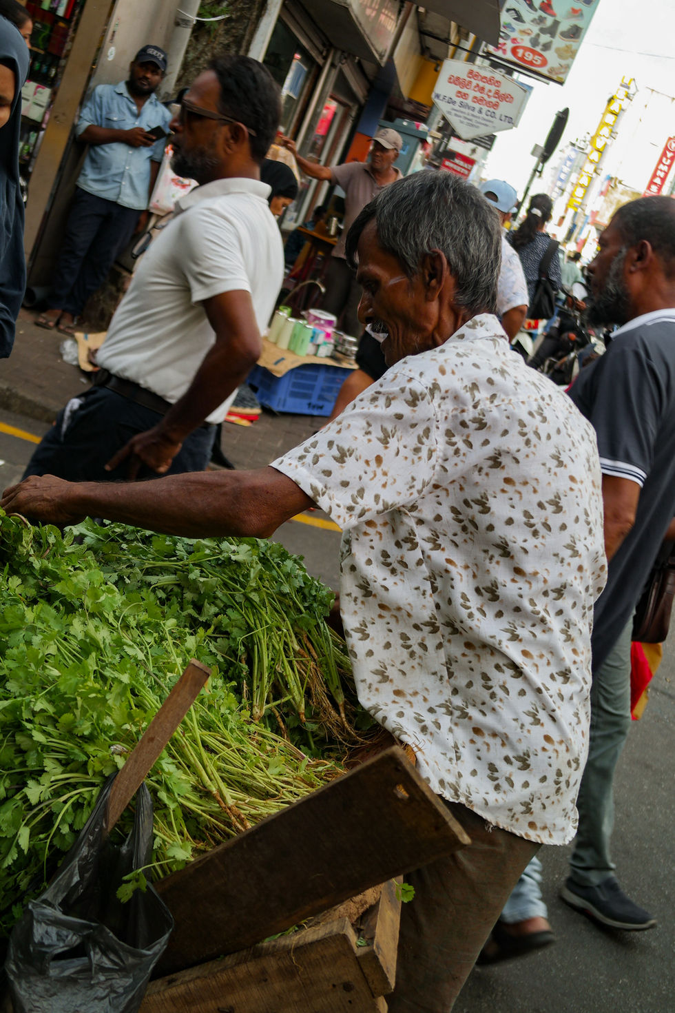 man selling food in the street of Colombo, Sri Lanka
