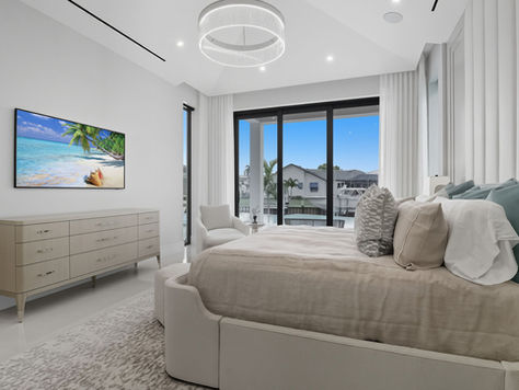 Primary bedroom suite in Naples custom waterfront home