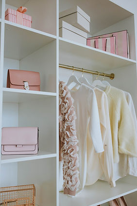 Organized modern closet in white and pink.