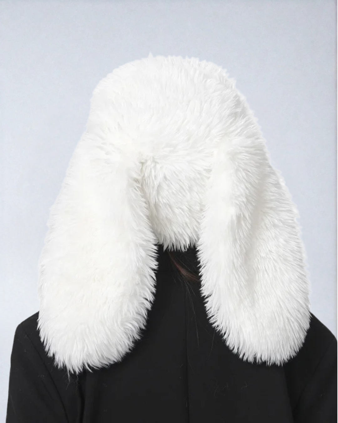 Back view of white flopsy bunny rave hat on model showing long ears
