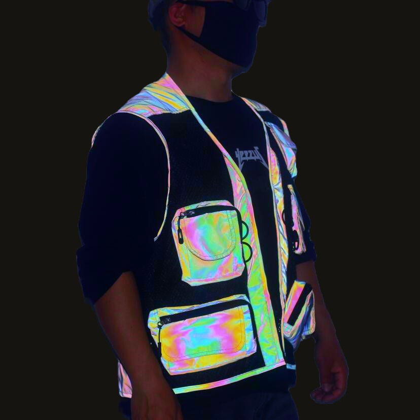 Thumbnail: Side view of the Rainbow Riot reflective utility vest under flash conditions showing multiple pockets and mesh construction