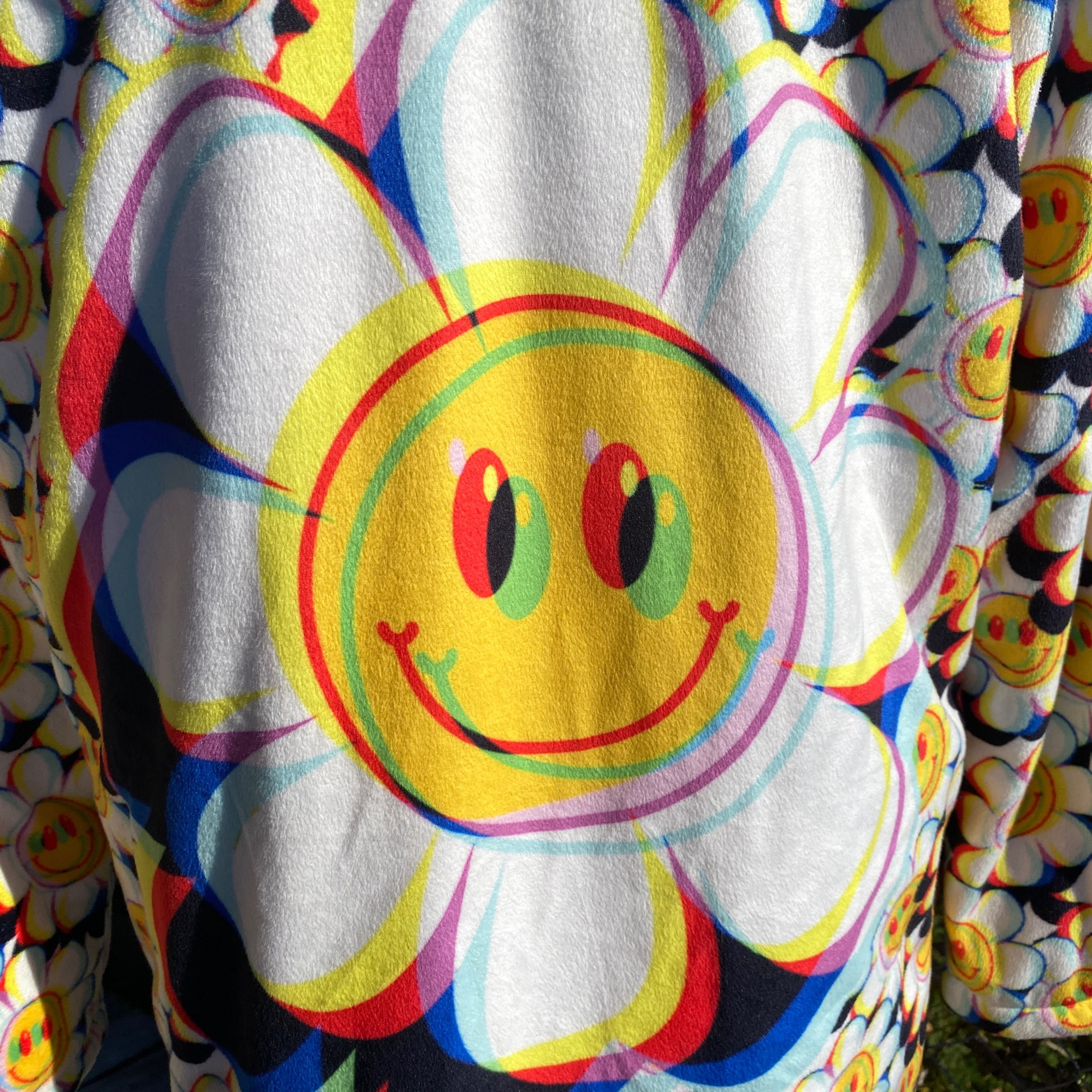 Crazy Daisy rave coat, back view on mannequin showing trippy daisy centre print