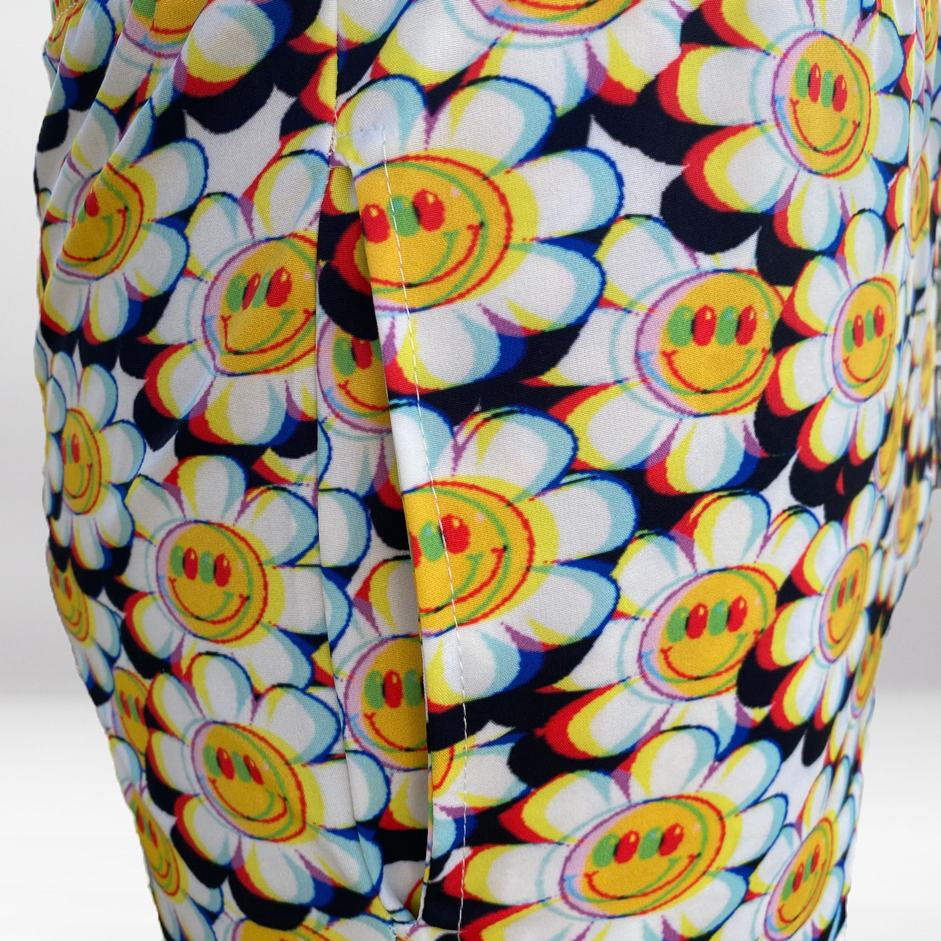 Close-up of the Crazy Daisy Beach Shorts, showing trippy print and side pocket