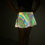 Thumbnail: Woman wearing Viper Strike Reflective Flared Mini Skirt, posing hands on hips in the dark.