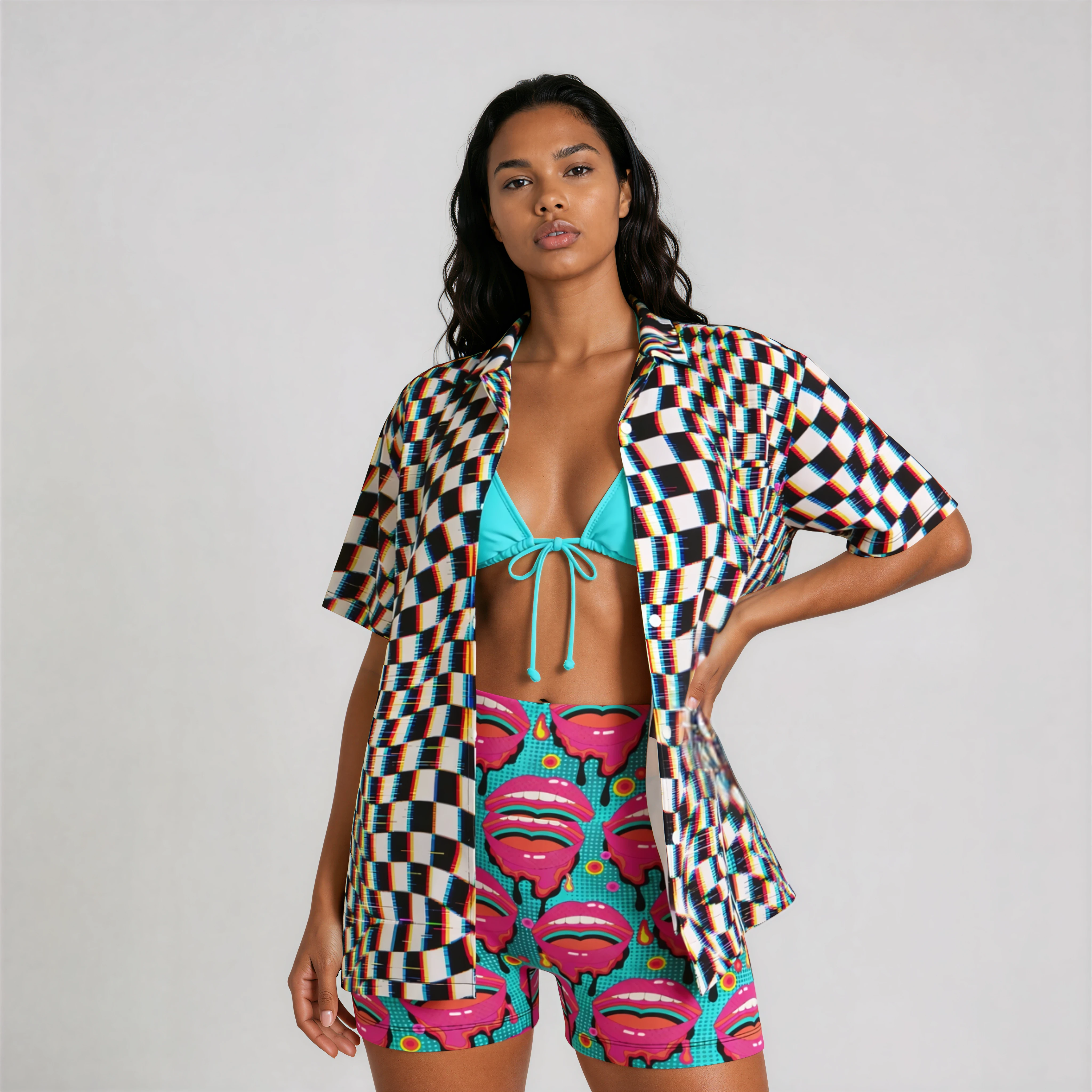 Front view of pop art printed yoga shorts on model styled with checkered Hawaiian shirt