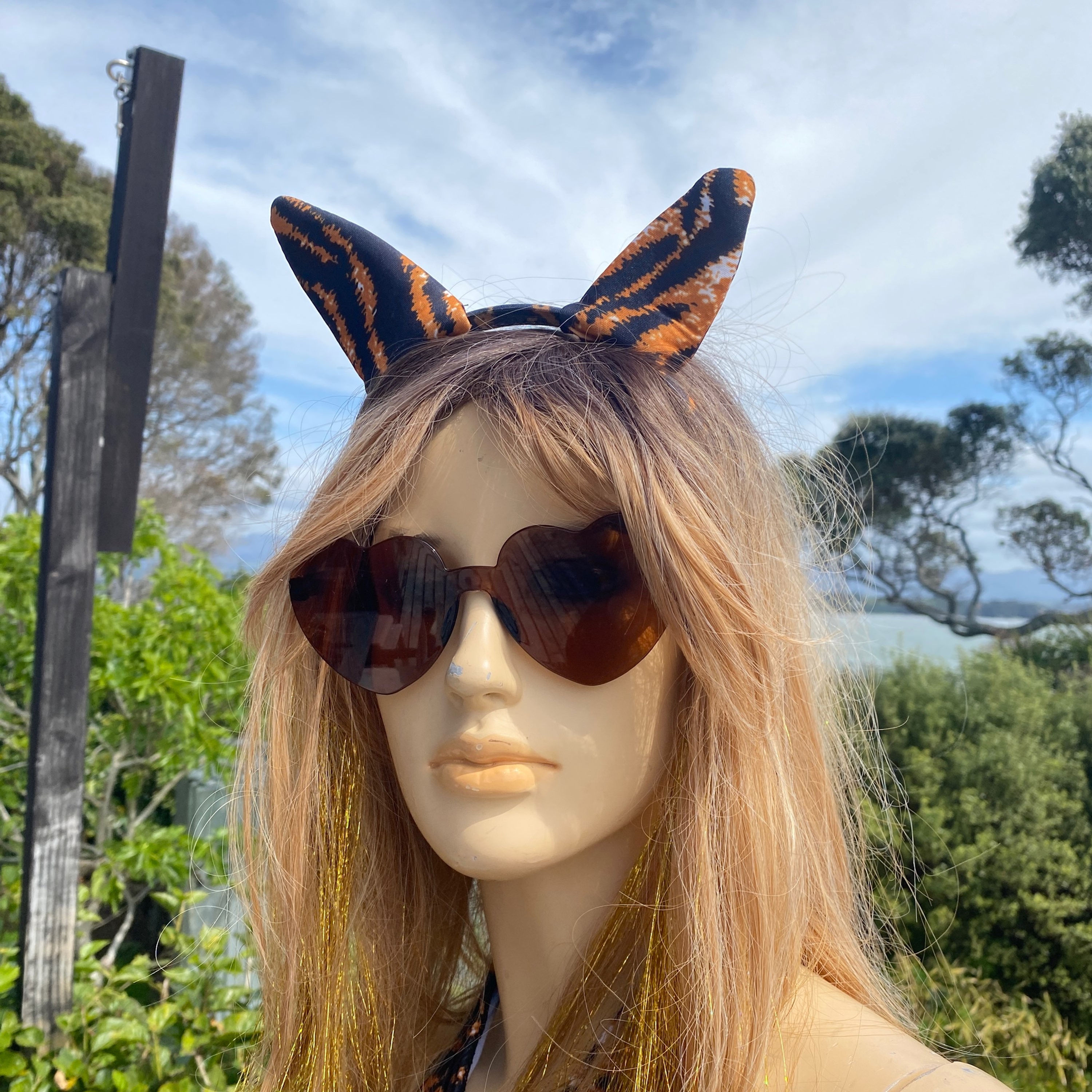 Detail view of the Faster Pussycat sexy Halloween costume on mannequin showing ears headband