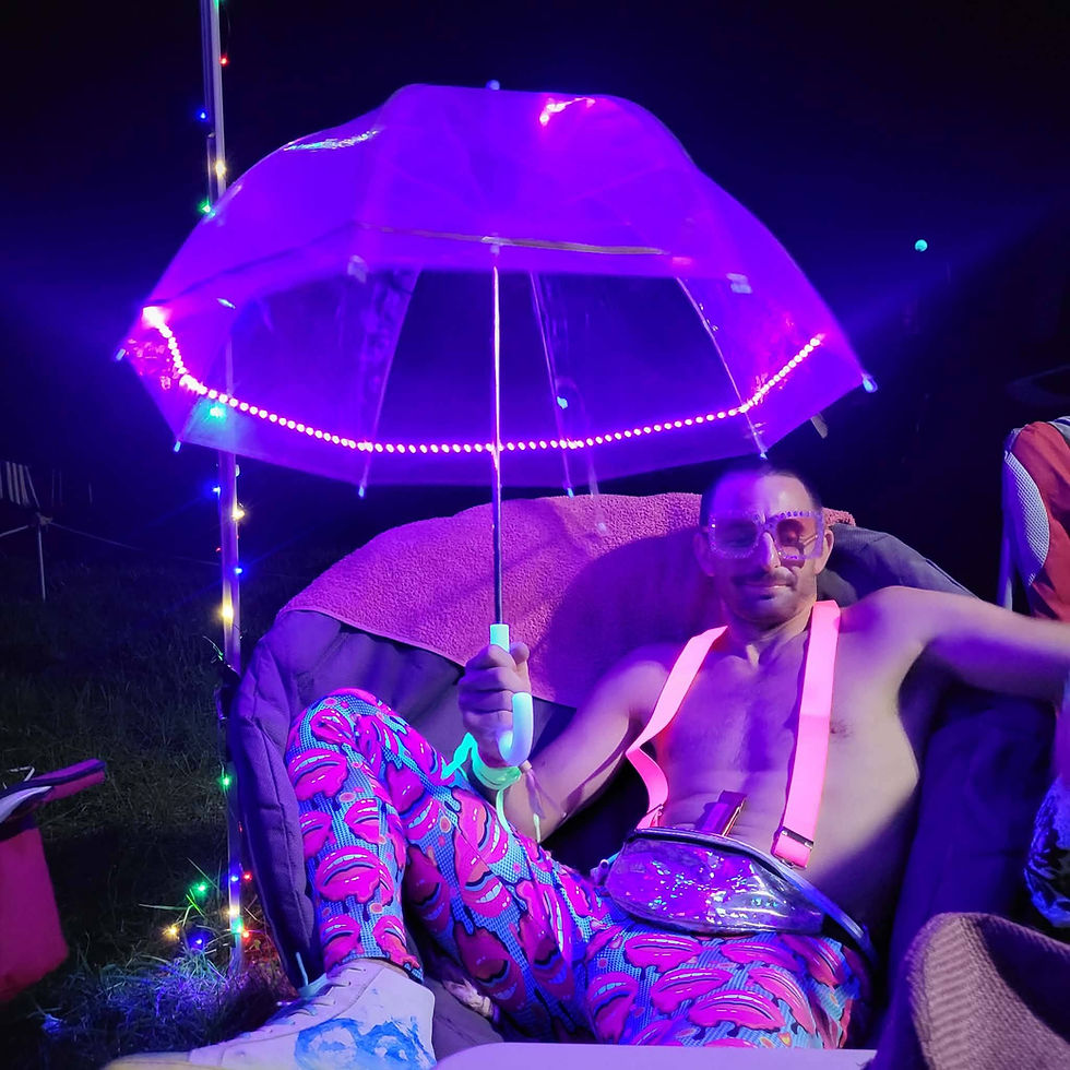 Thumbnail: Lifestyle image of man wearing Lipsy Leggings at music festival at night