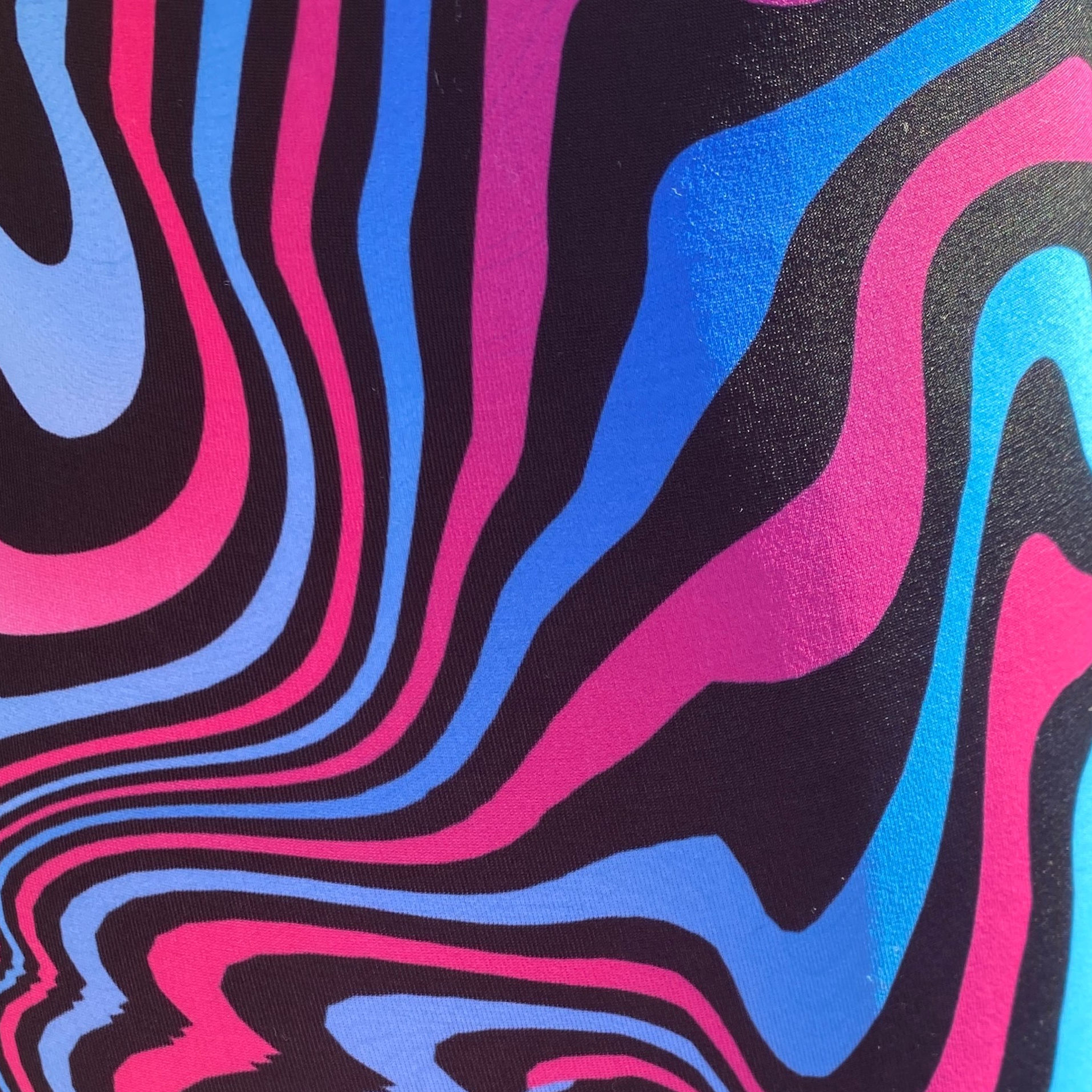 Close of Gender Fluid pink and blue marble print spandex