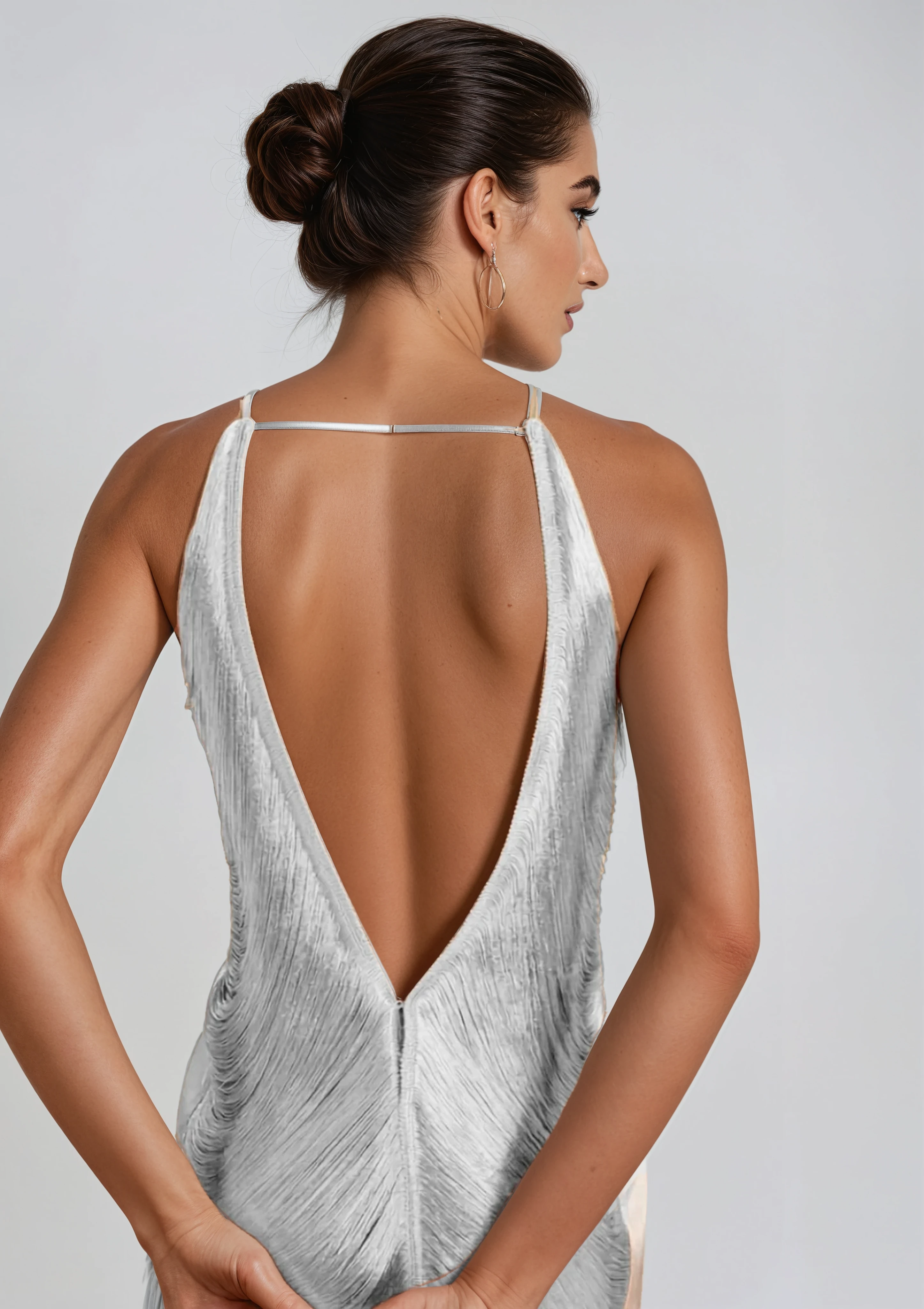 Back view Liquid Silver cocktail dress on model showing draped fringing