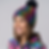 Side view of the Happy Hardcore pompom beanie in rainbow colours
