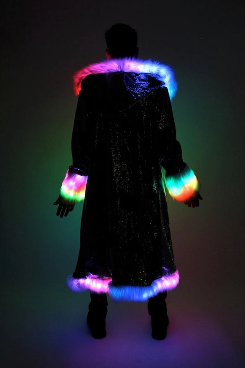 Thumbnail: Back view of the Ultimate festival coat on model, in dark studio, showing programmable LED lighting
