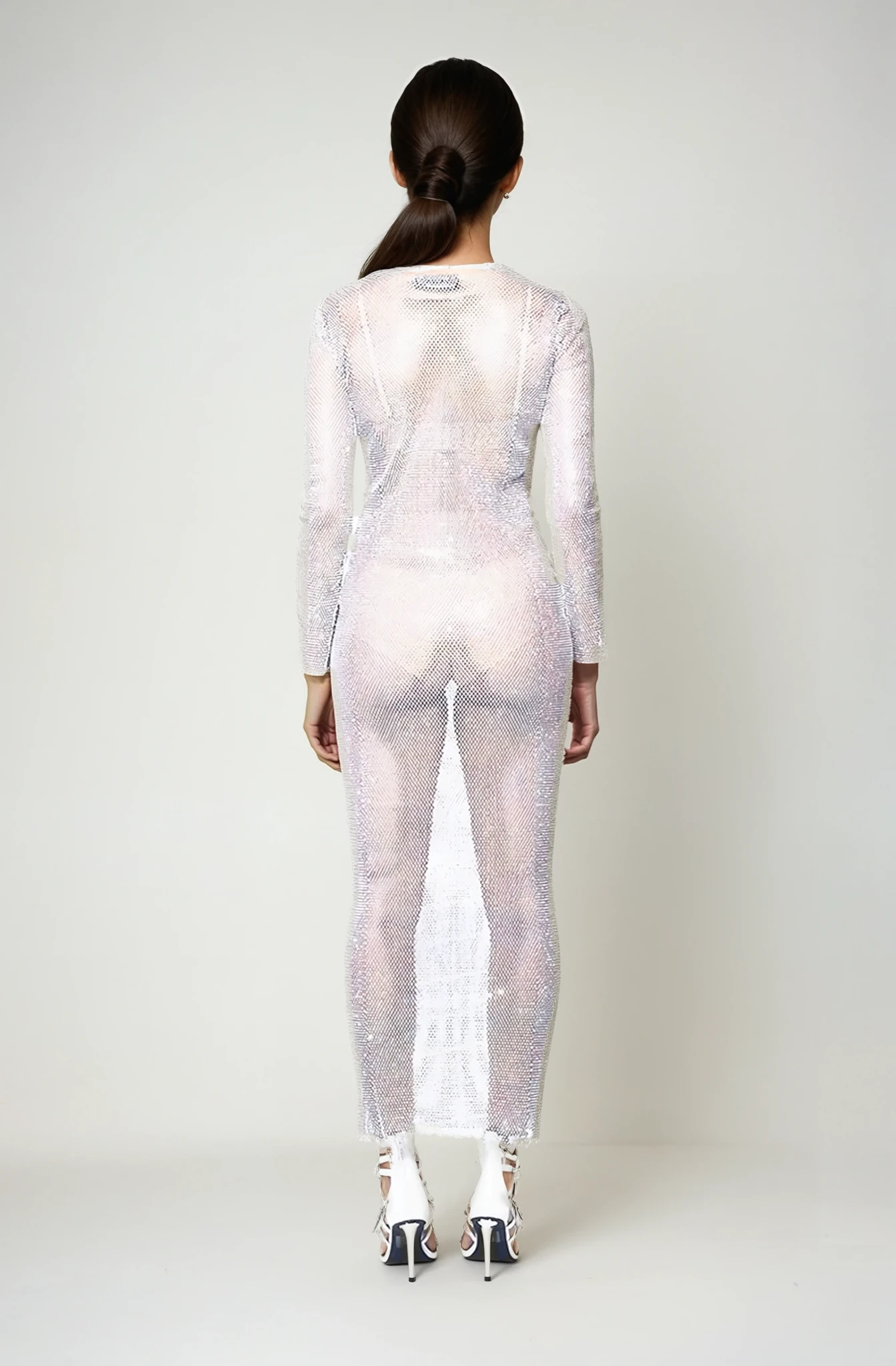 Back view of the Frostlight white rhinestone mesh maxidress on model showing sparkles and transparent netting fabric