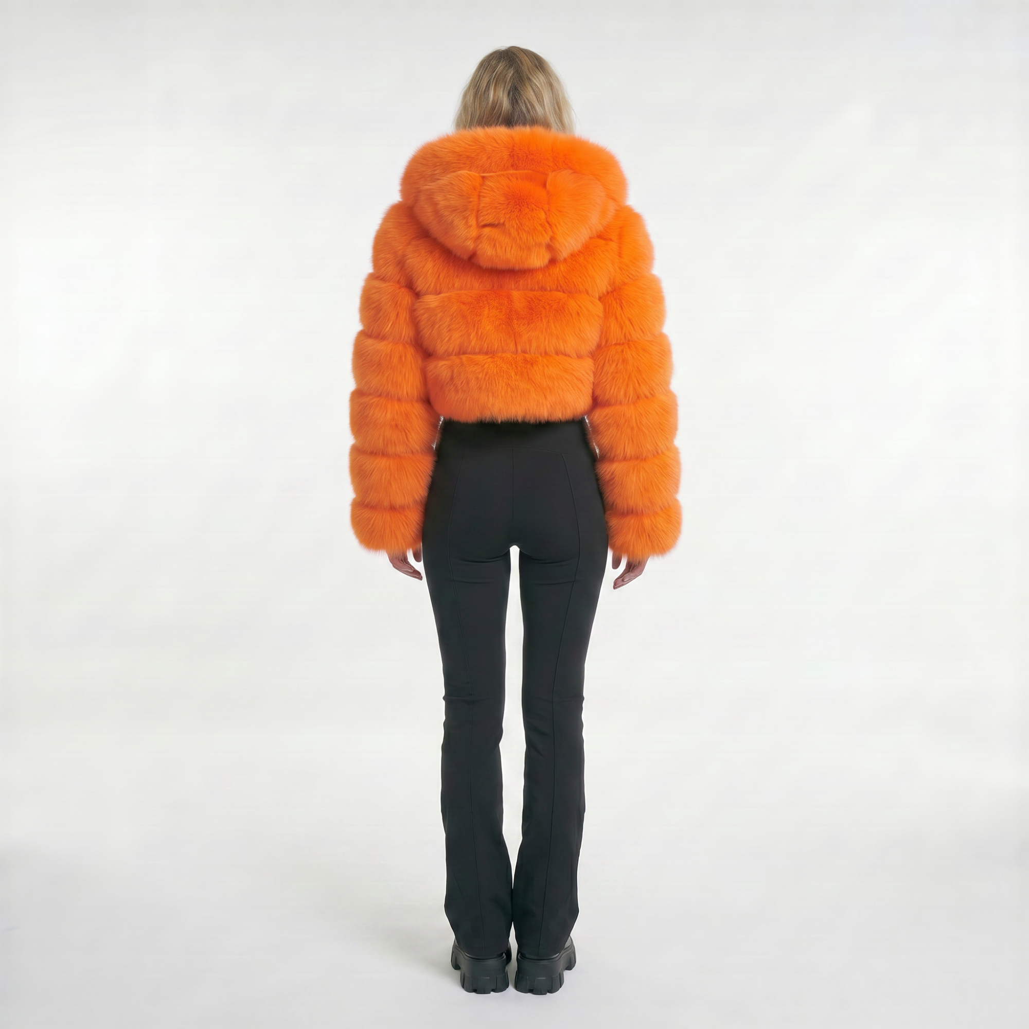 Back view of the Voltage Muse neon orange cropped fur jacket on model with hood down