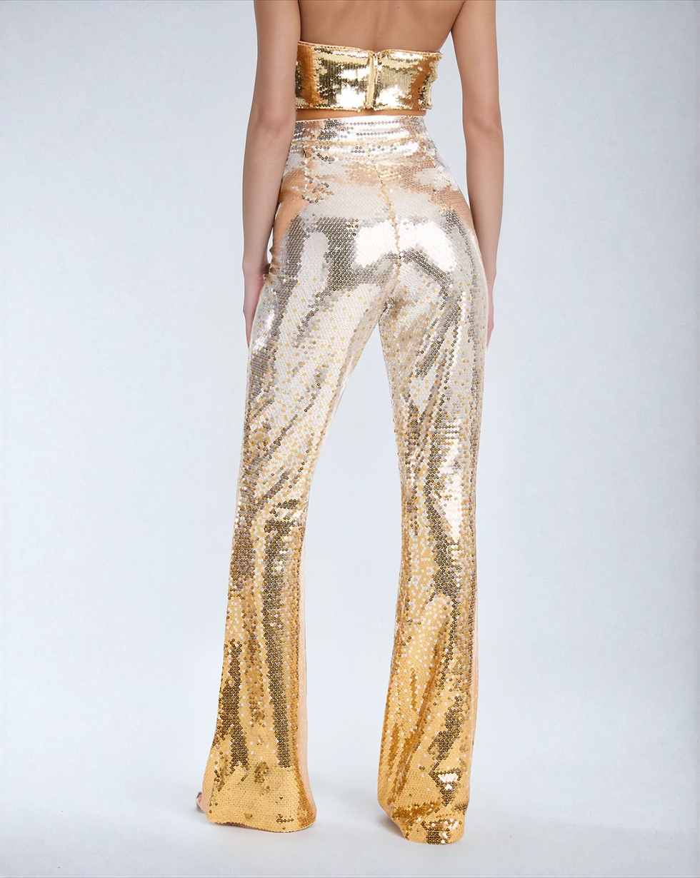 Lower back view of the Molten gold sequin flare pants on model showing design and fit