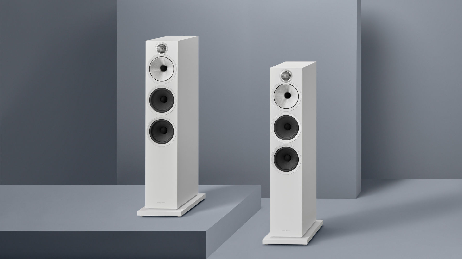 White Bowers & Wilkins 603 S3 speakers in muted blue setting, designed by Goodwin Hartshorn