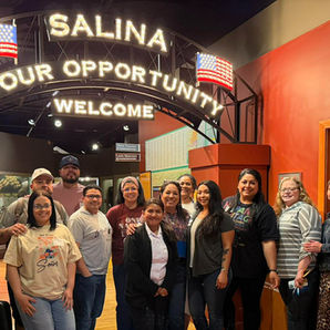 A  group of Latinos at the Smoky Hills Museum entry