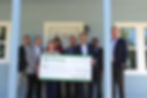 Brett Smith (Central Bank) presents Carrie Woerdeman (Executive Director of HOME, Inc.) with check for the 2025 Hunt for Housing Visionary Sponsorship while on the HOME, Inc. Home Tour - A special tour of our new construction for our Visionary Sponsor.