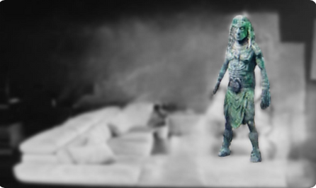 Photo rendering based on a report from a patient with LHON & Charles Bonnet Syndrome derived from a video by Vicky Hamilton, courtesy of The Queensland College of Art, Griffith University. Image shows an Aztec man in a blurry grayscale room.