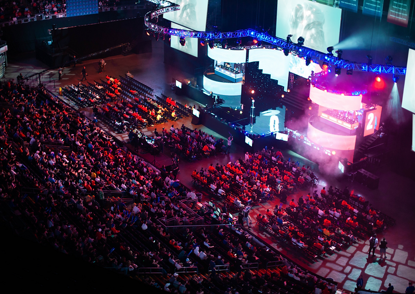 A phote of a large stage and audience at a conference event