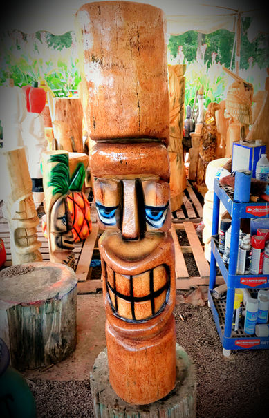 Tiki Murph carved palm face tiki with blue eyes.