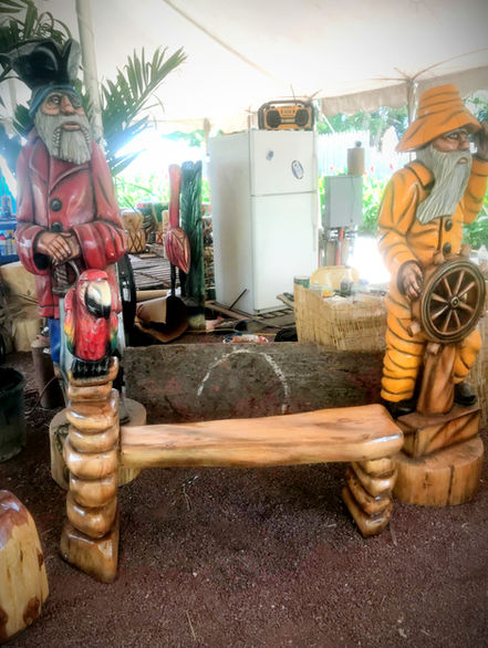 Tiki Murph chainsaw carved white pine parrot bench