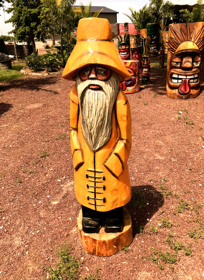 Tiki Murph white pine carved fisherman in yellow raincoat named "Old Saltie".