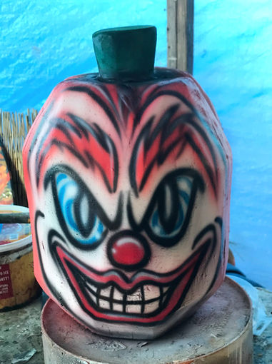 Tiki Murph white pine carved evil clown pumpkin.