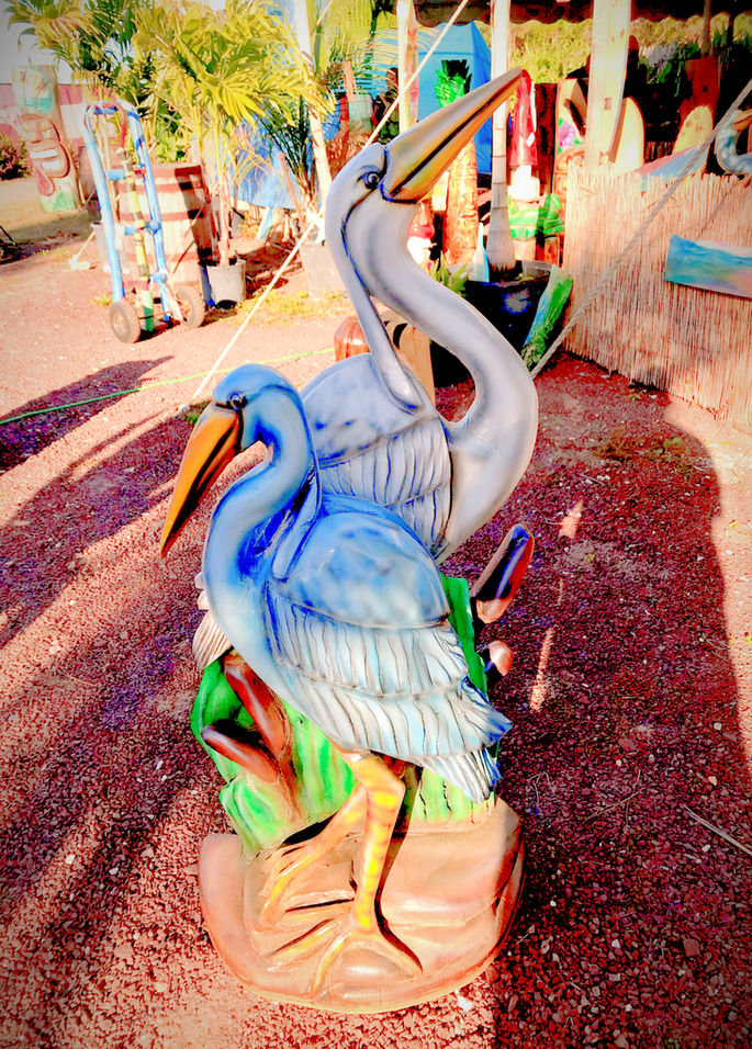 Tiki Murph white pine carved herons one blue one white with cattails.