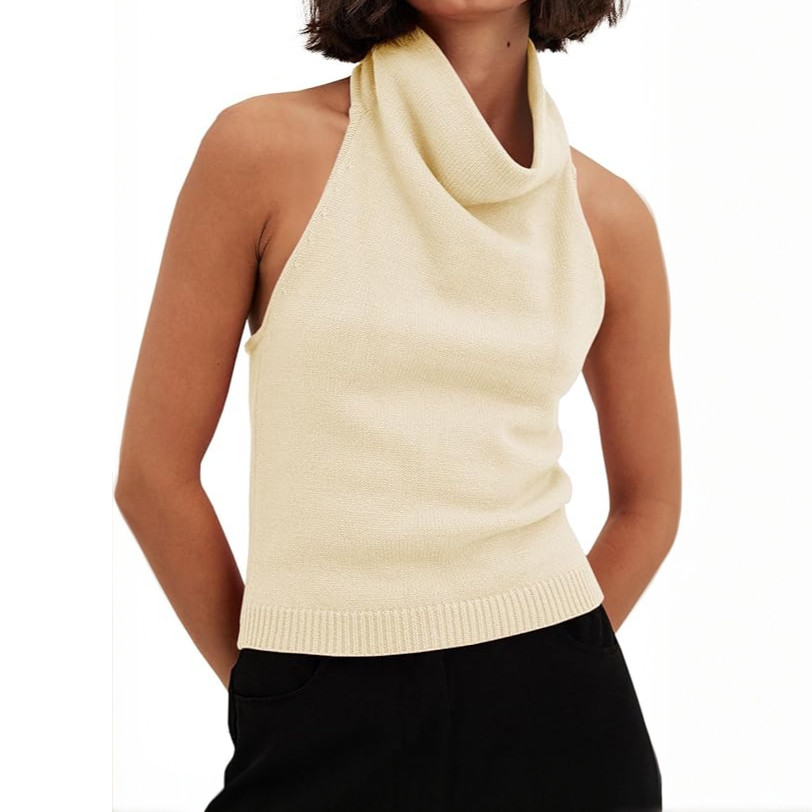 Woman wears stylish cream halter neck cowl neck knit top.